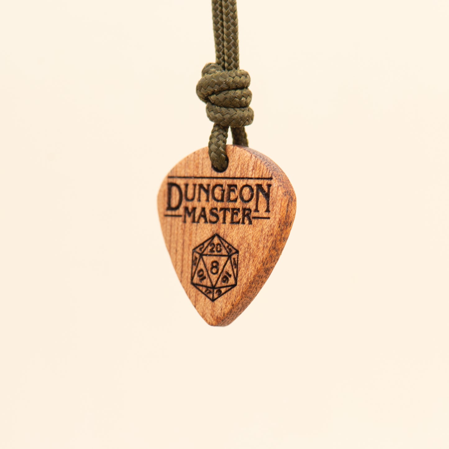 Angled detail of a handcrafted Dungeon Master wooden pendant with D20 dice
