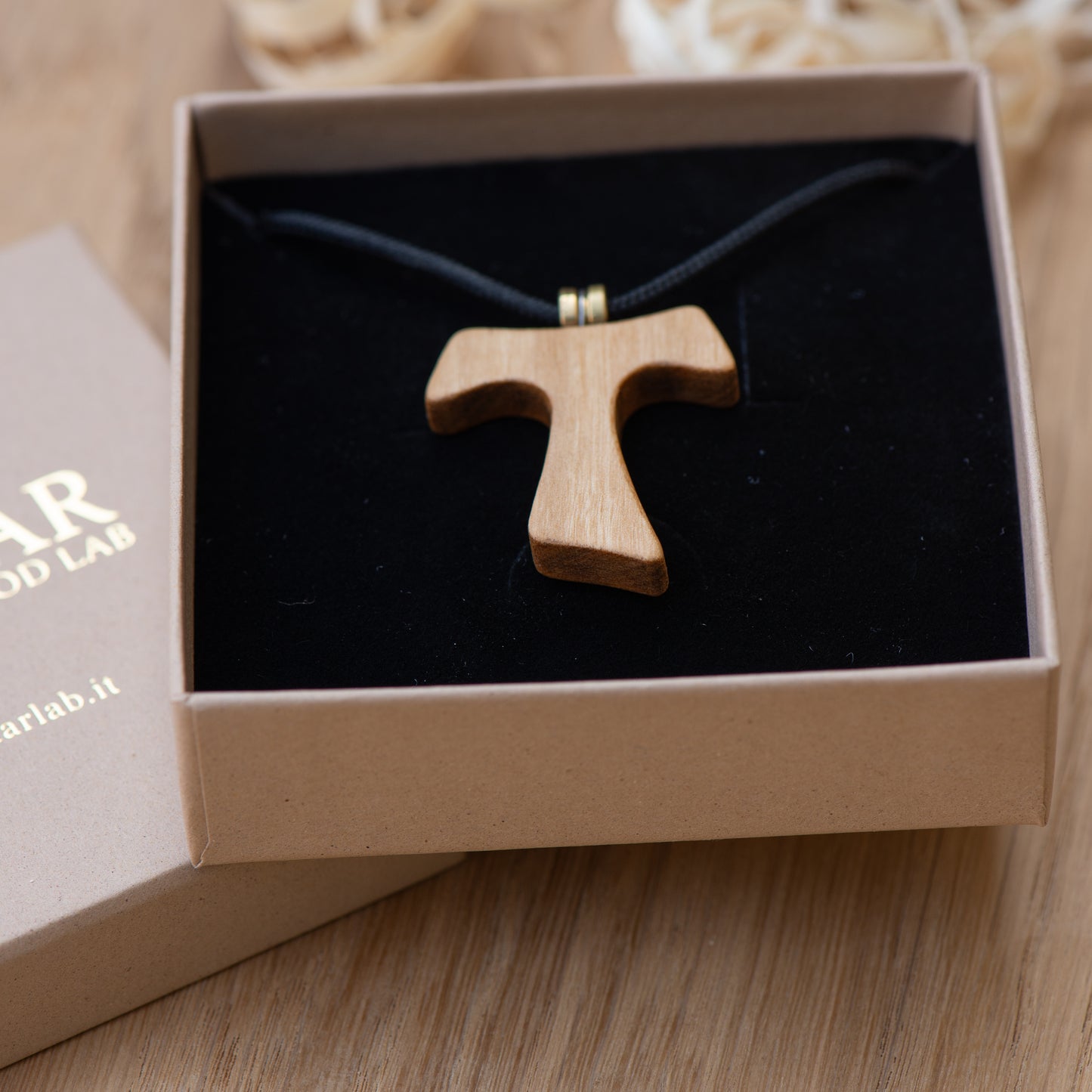 Handmade olive wood Tau cross pendant showing natural grain and oil finish