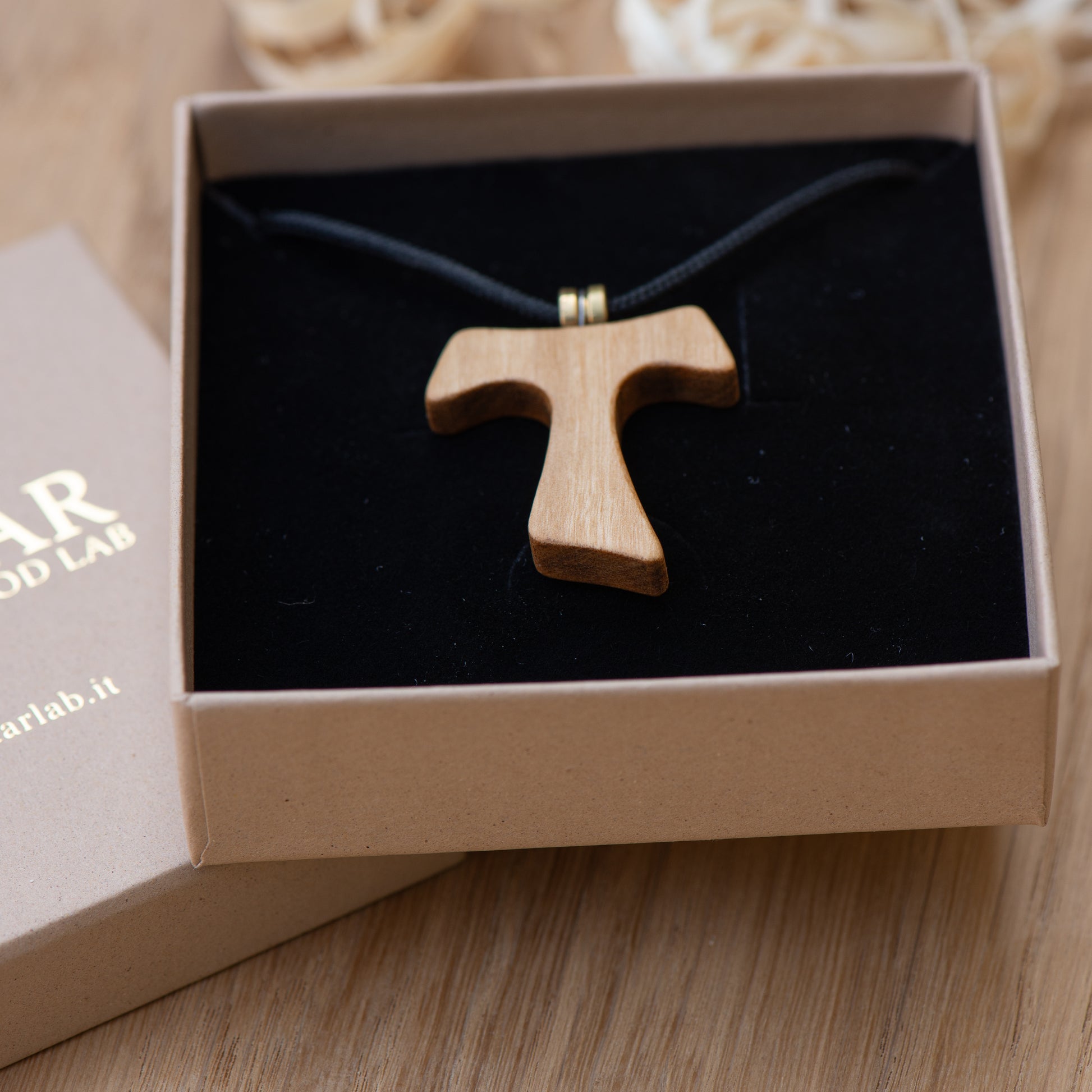 Handmade olive wood Tau cross pendant showing natural grain and oil finish