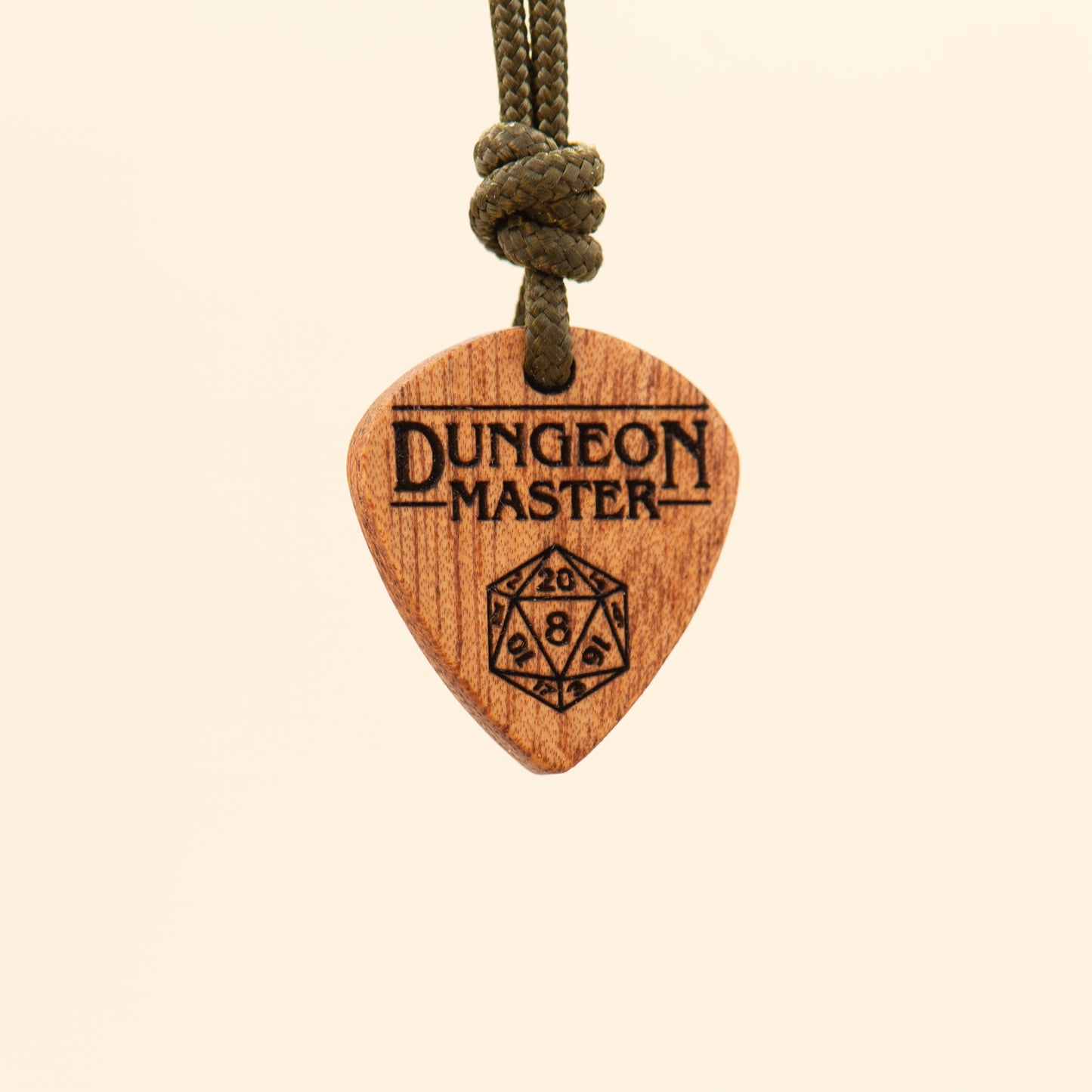 Angled view of a laser engraved Dungeon Master pendant made from natural wood
