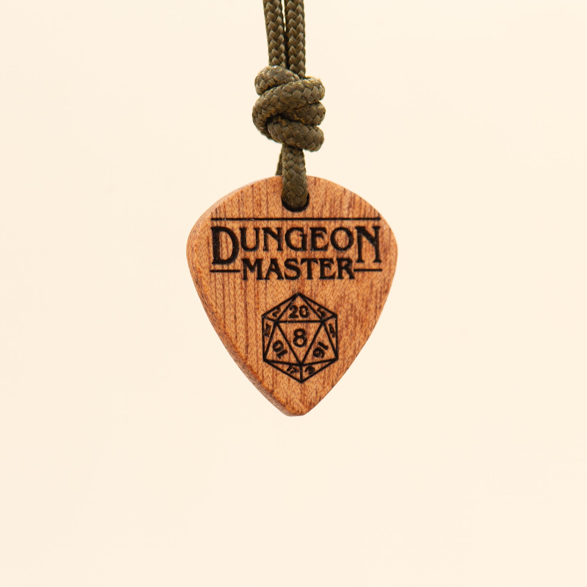 Angled view of a laser engraved Dungeon Master pendant made from natural wood