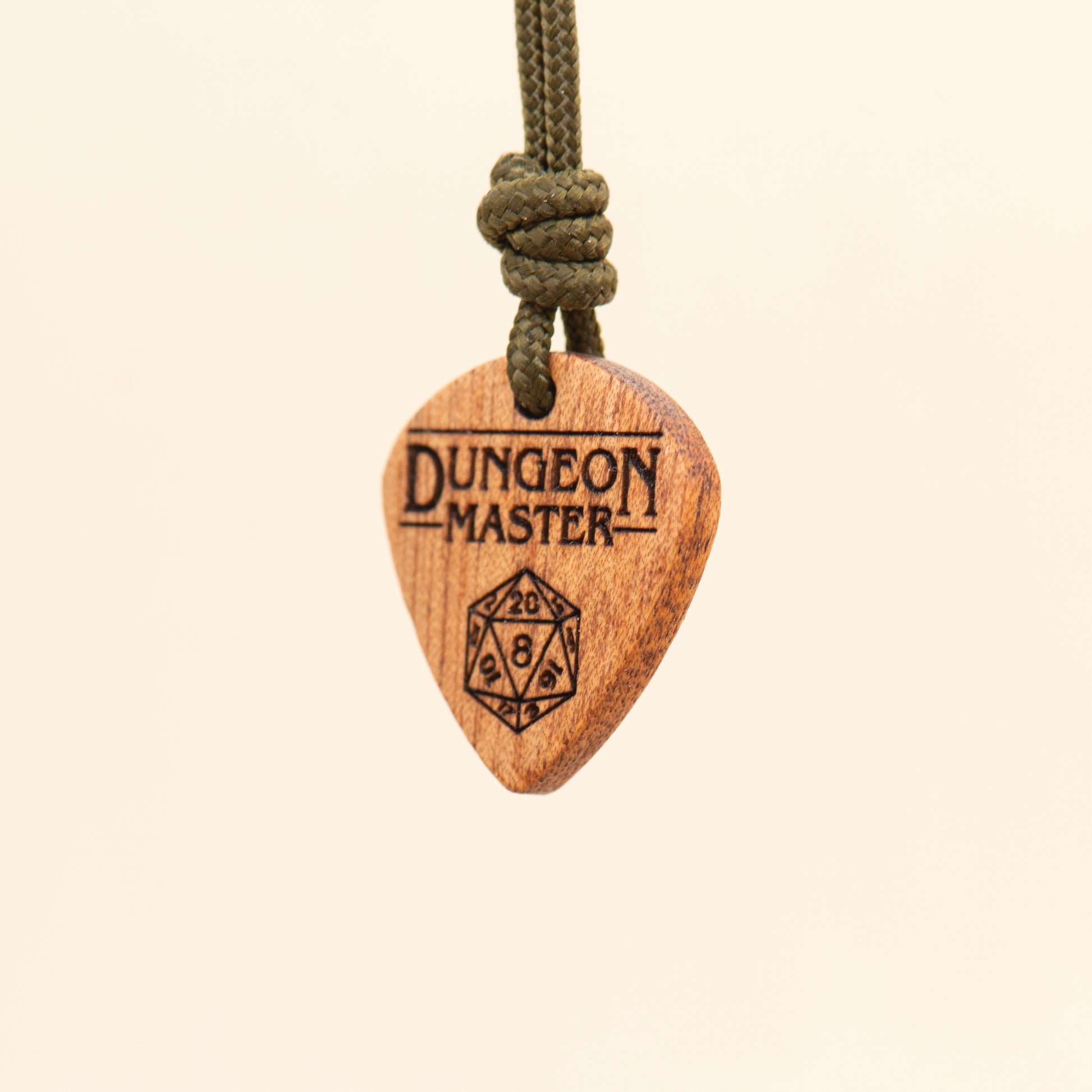 Angled detail of a handcrafted Dungeon Master wooden pendant with D20 dice